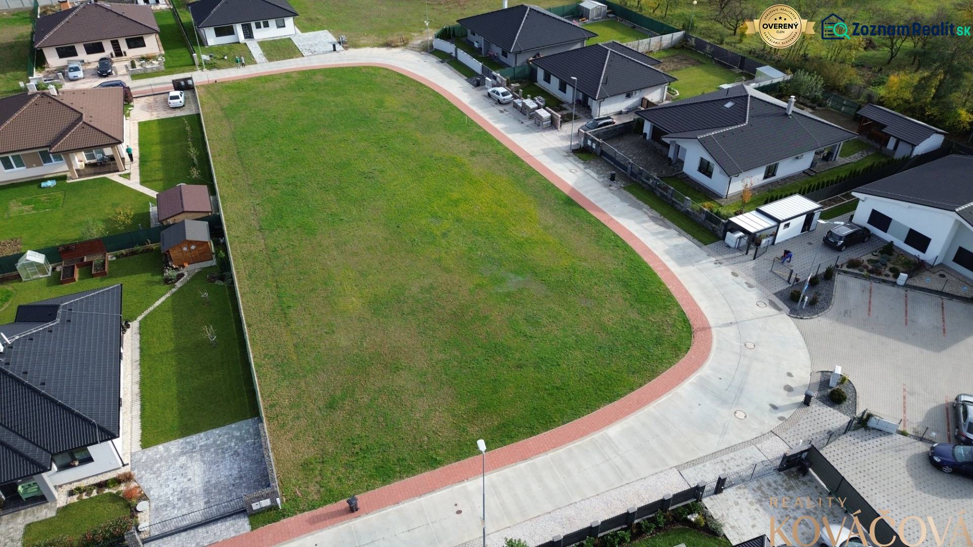 Aerial view of residential plots in Kočovce, surrounded by family houses.