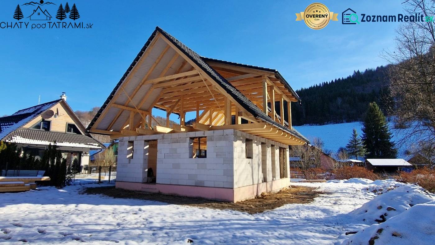 A cabin construction in Mýto pod Ďumbierom in a winter landscape with a wooden structure.