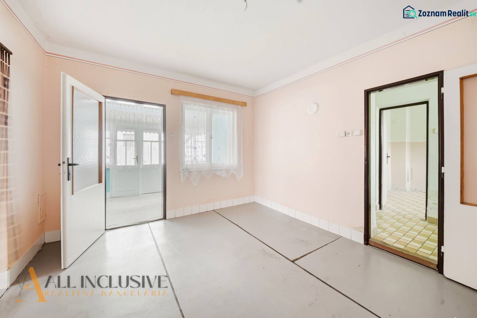 Interior of a family house with white walls and glass doors without wooden decor.