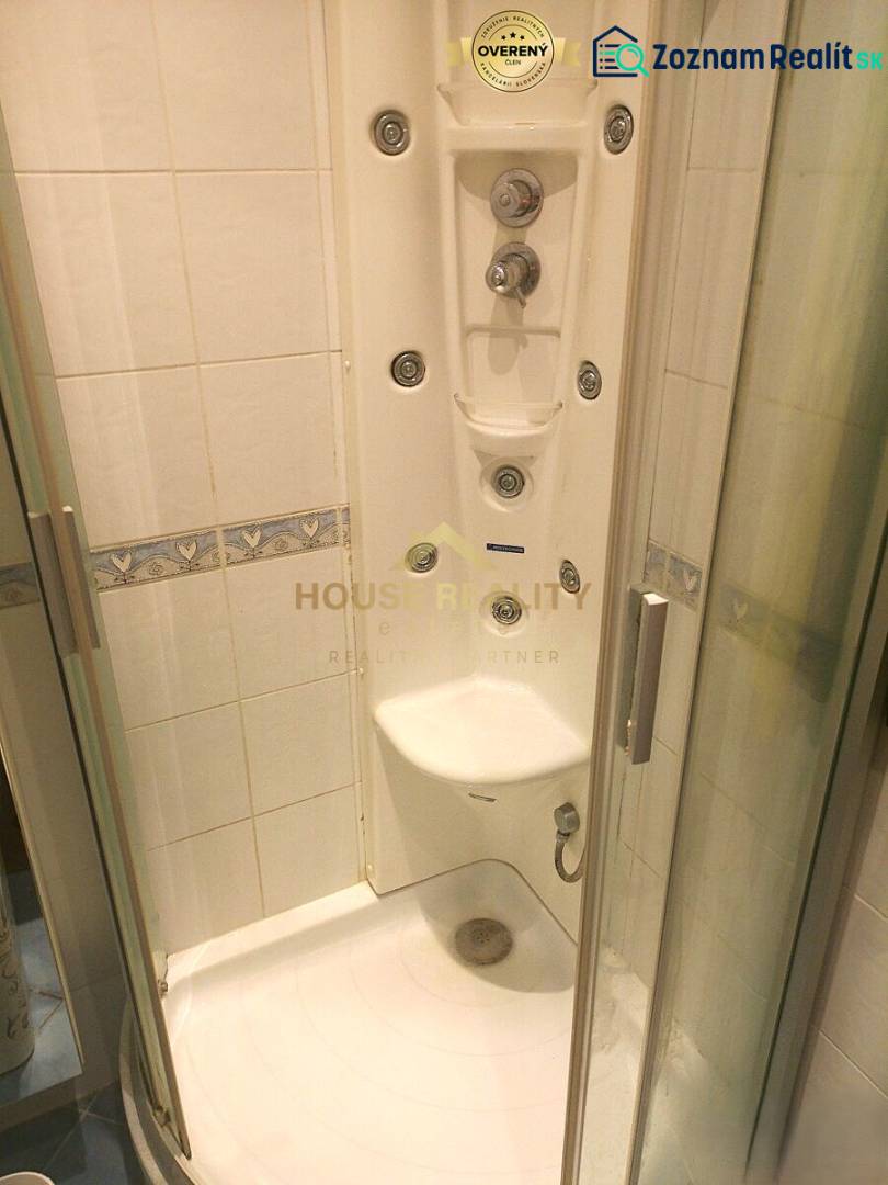 A shower cabin with hydromassage jets in a 2-room apartment.