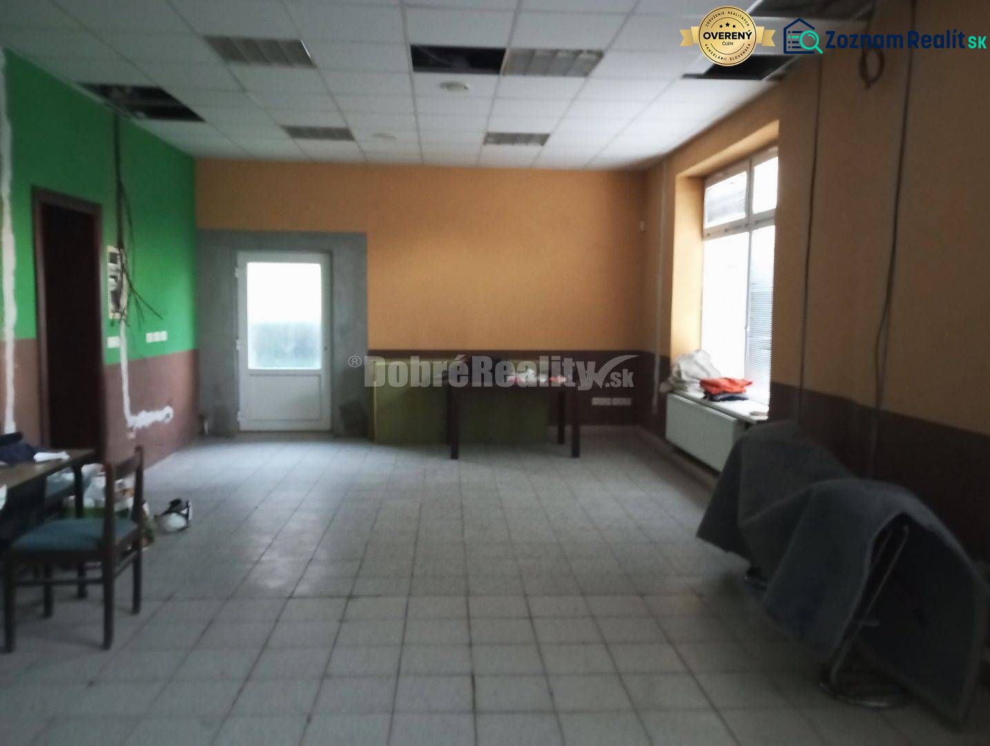Spacious commercial spaces with windows and doors, tiled floor.