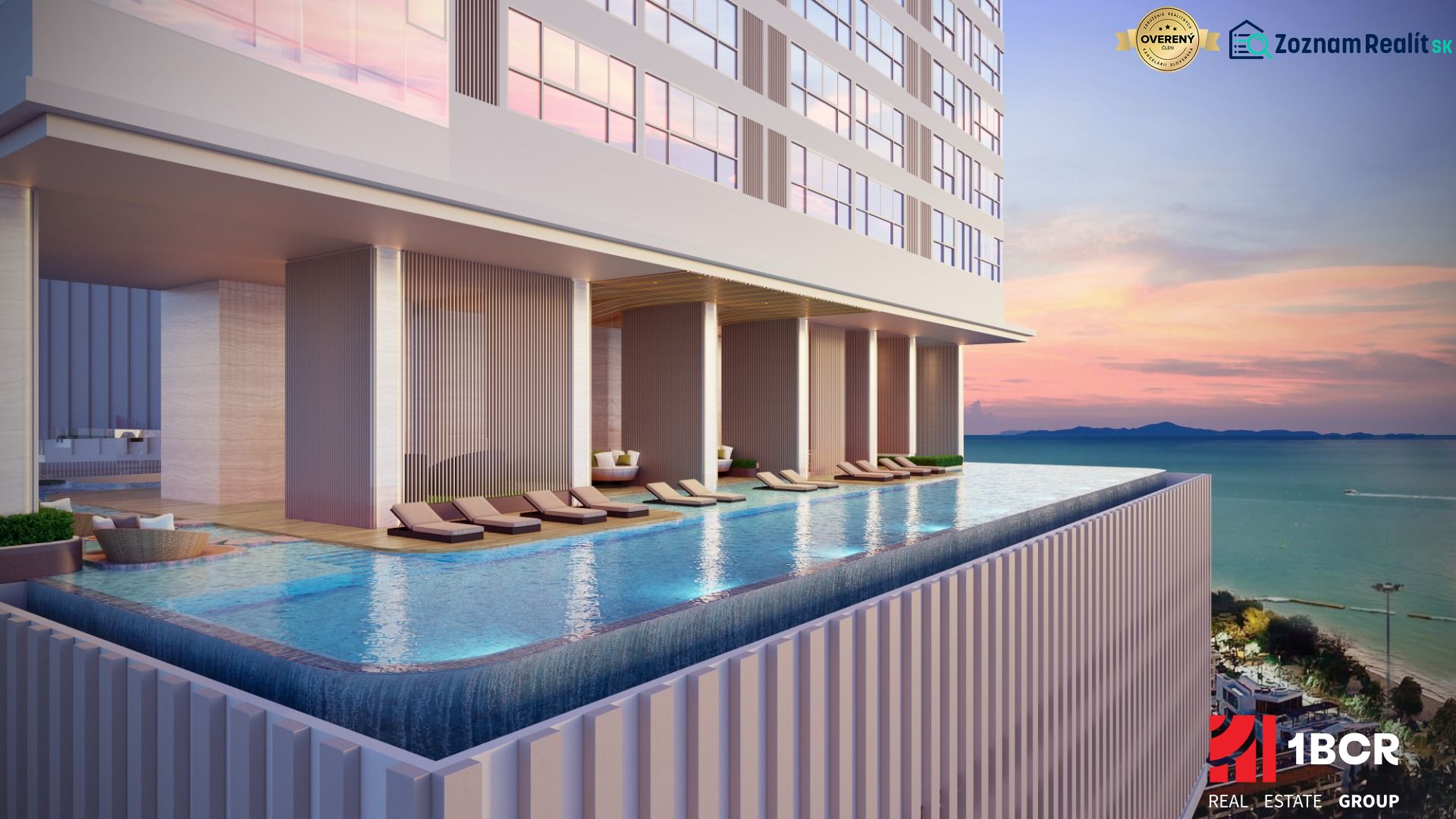 Swimming pool with loungers in Pattaya, construction of apartments with a view of the beach at sunset.