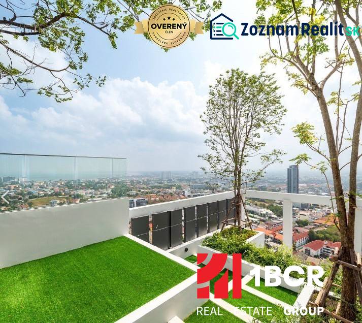 Rooftop terrace with a view of the city of Pattaya and residential buildings.