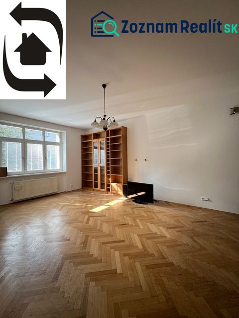 A spacious living room with a wood-patterned floor in a 5 or more room apartment.