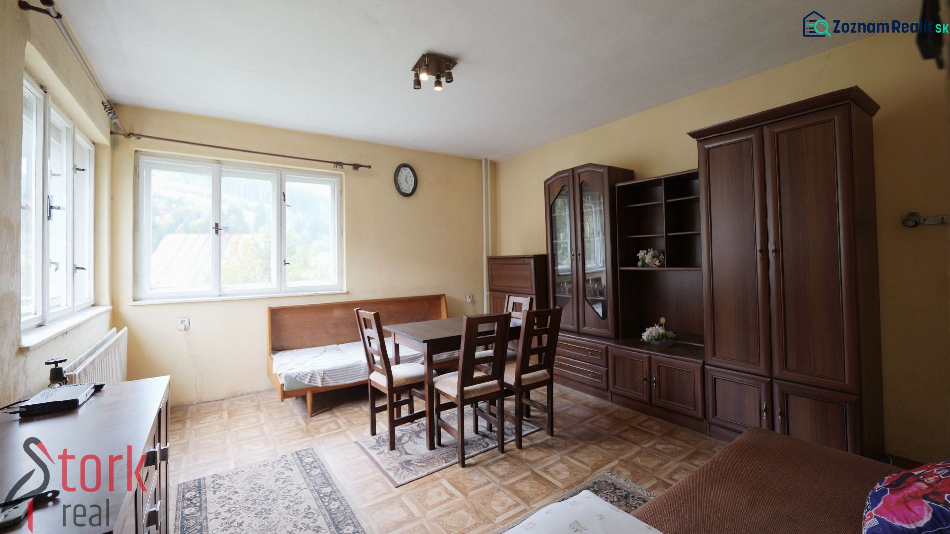 A living room in a family house with light furniture and a wooden decor floor.