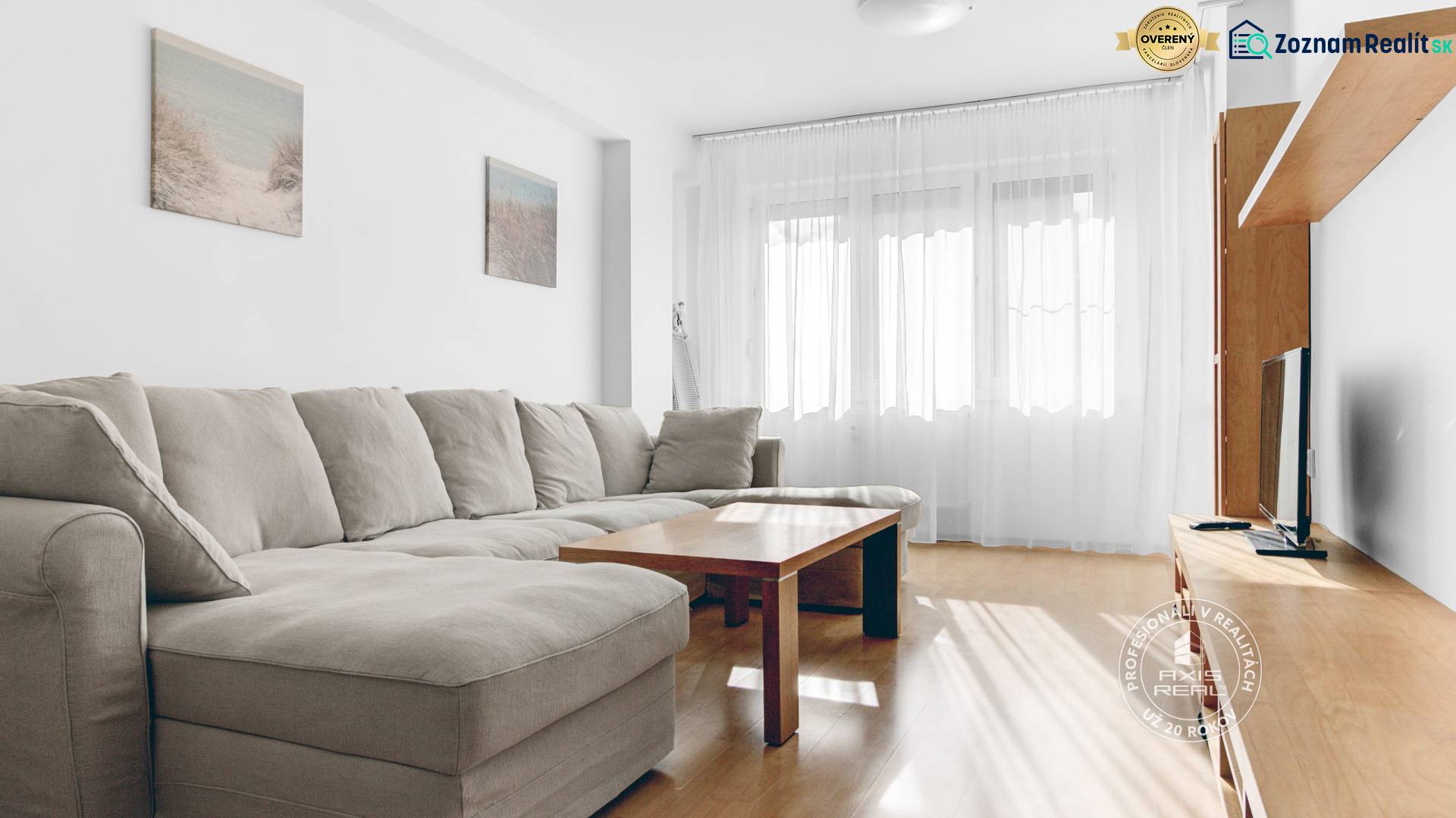 Living room with a comfortable sofa, coffee table, and wooden decor flooring.
