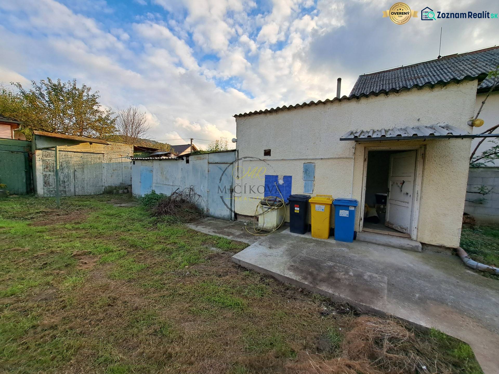 A family house on Mechenická Street in Podhorany with a yard and containers for sorted waste.