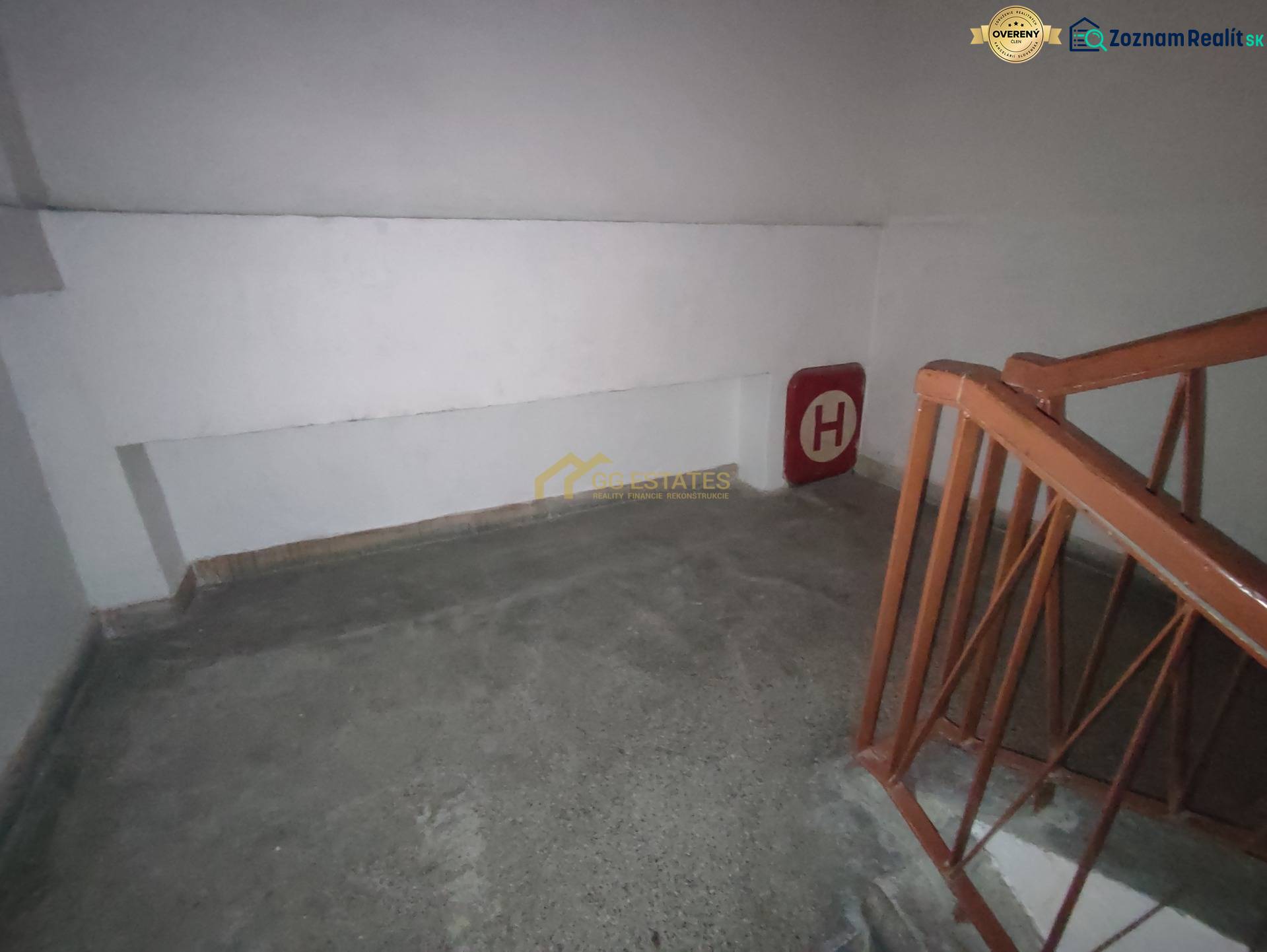 Interior of the staircase in the Office, with a railing and fire hydrant signage on the wall.