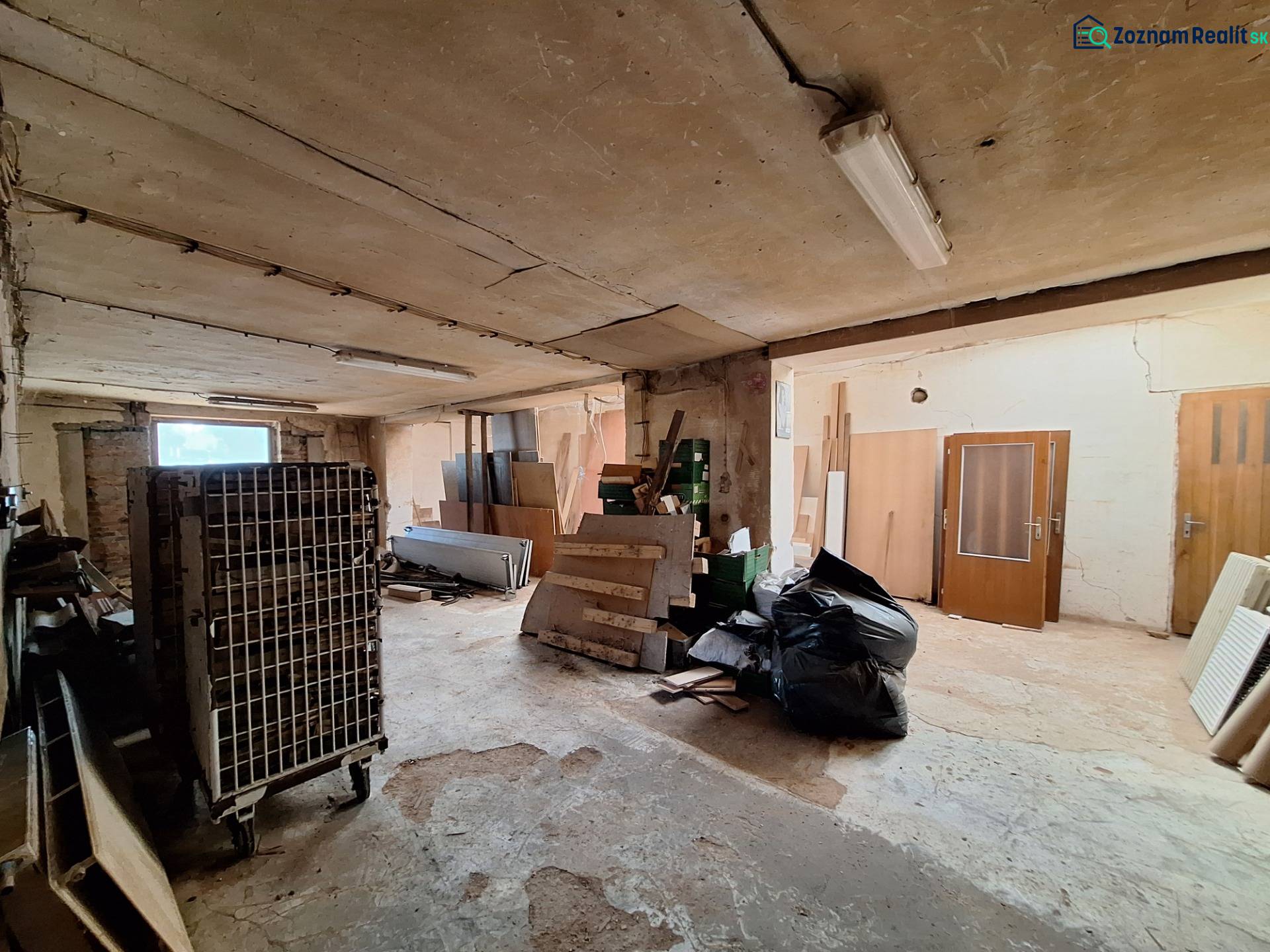 Warehouses and halls with various construction waste and equipment, including old doors.