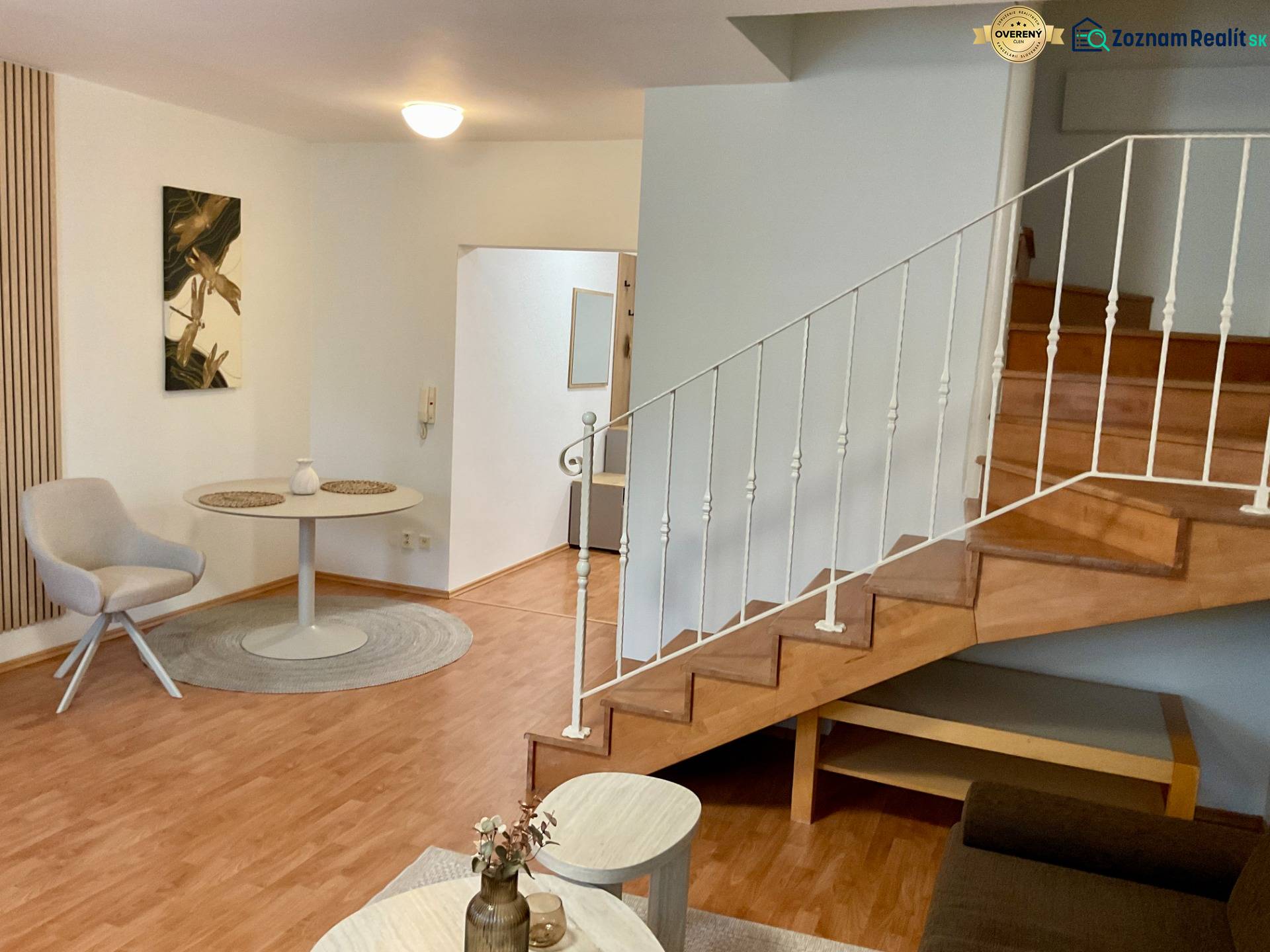 Interior of a 3-room apartment with a wooden decor floor and a staircase.