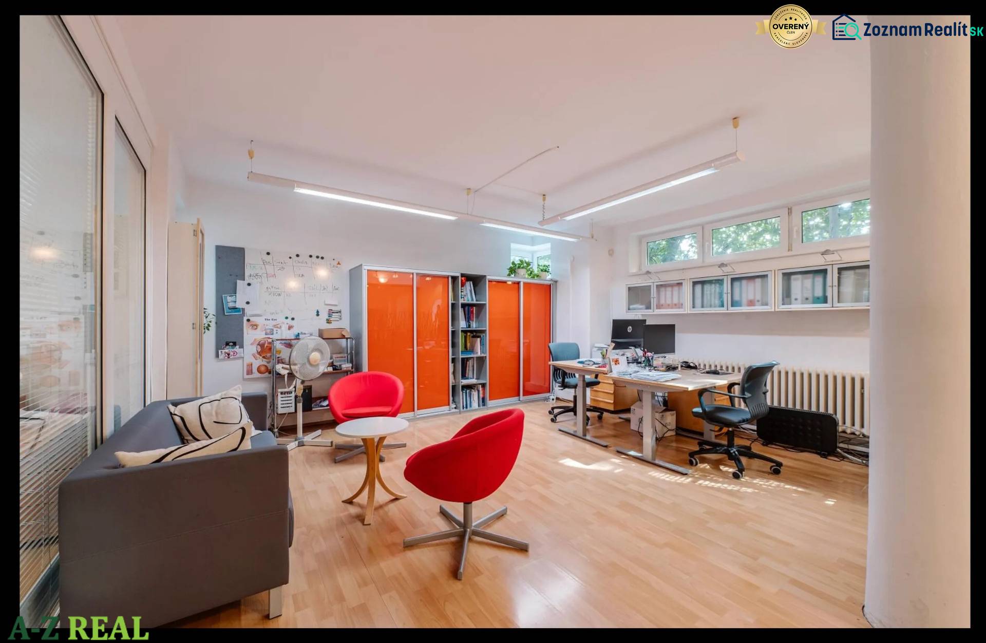 Interior of a family house with an office area, wooden decor flooring, orange cabinets.