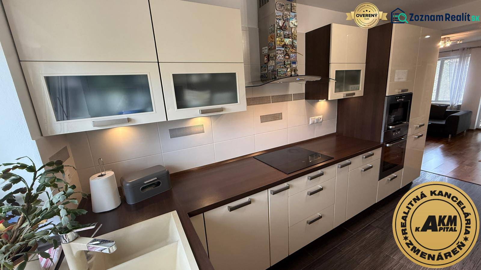 A kitchen in a 2-room apartment with white cabinets and a wood-patterned floor.