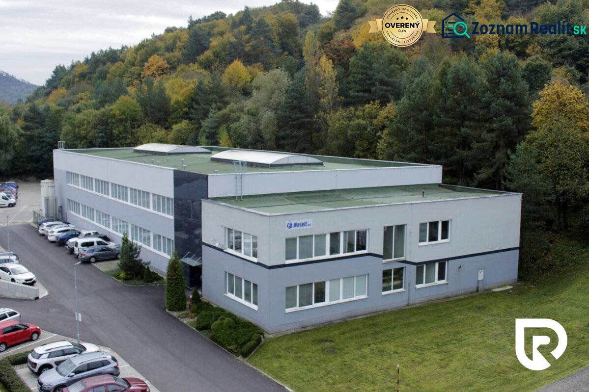 The building on Trenčianska Road in Nová Dubnica, surrounded by forests, serves as warehouses and halls.