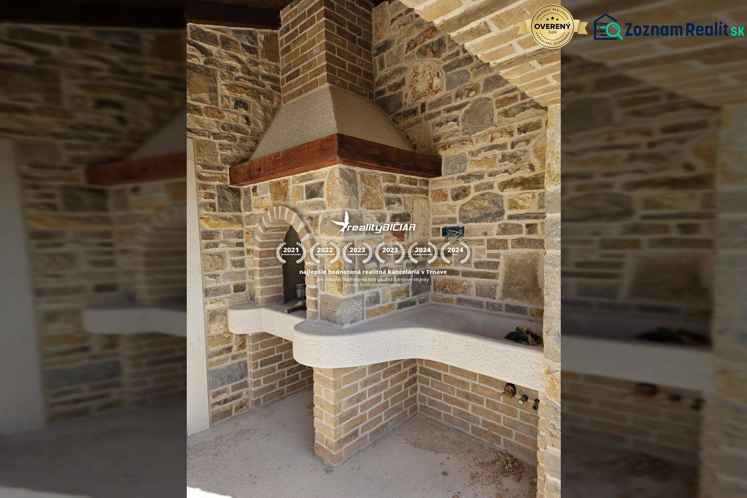 A fireplace with stone cladding in a family house, decorated with brick details.