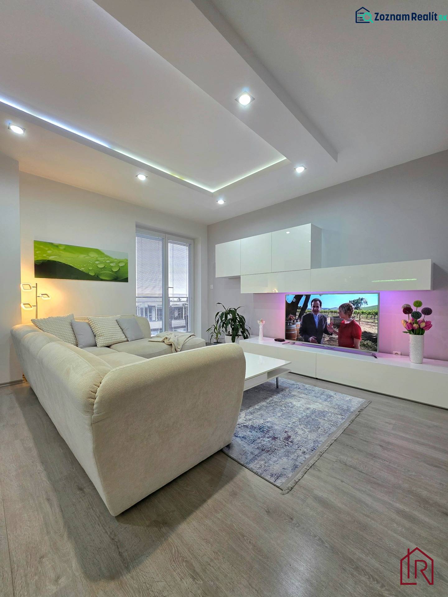 Living room in a three-room apartment with a comfortable sofa, wooden decor flooring, LED lighting.