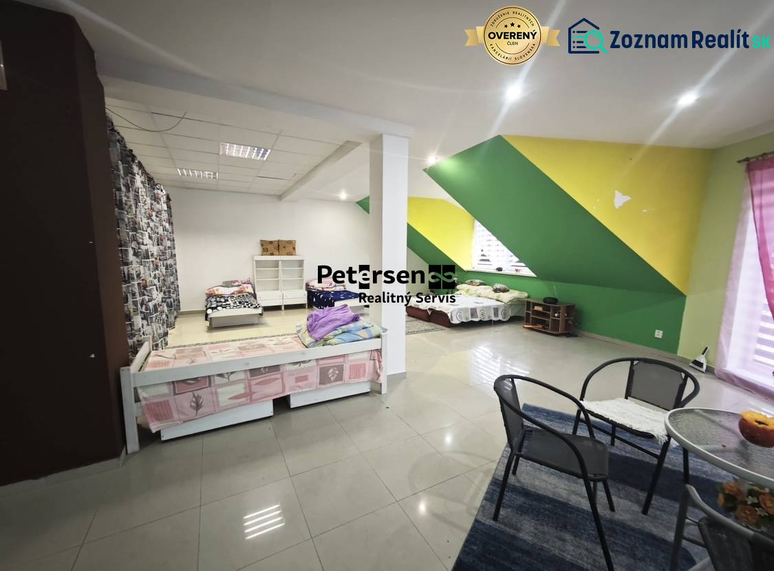 A bedroom in a family house with colorful walls and simple furniture.