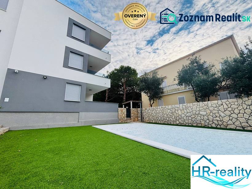A holiday apartment in Novalja with a swimming pool and landscaped garden, modern architecture.