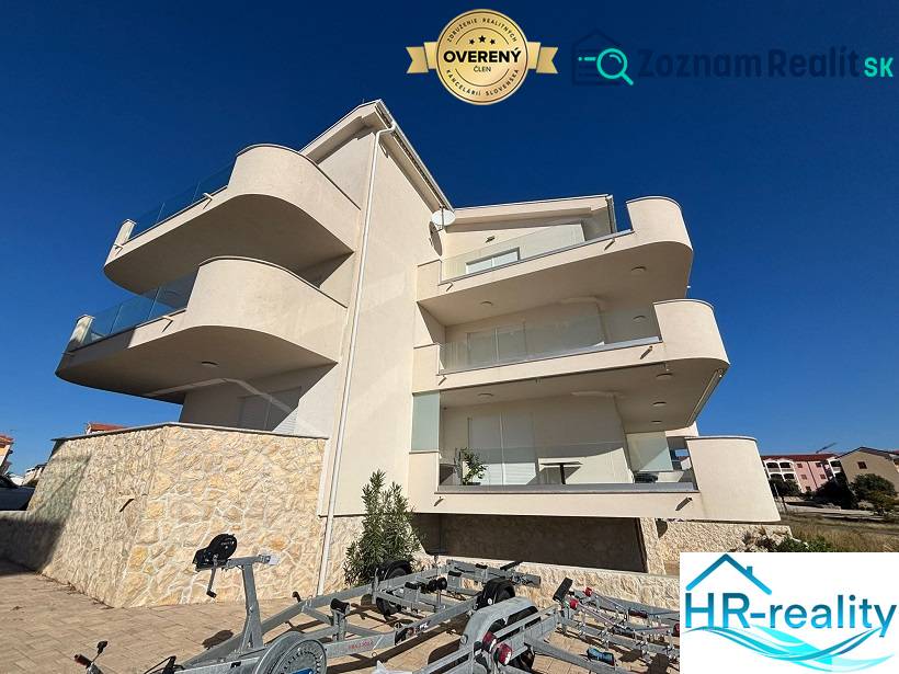 White facade of the Recreational Apartment in Povljana, terraces, and blue sky.
