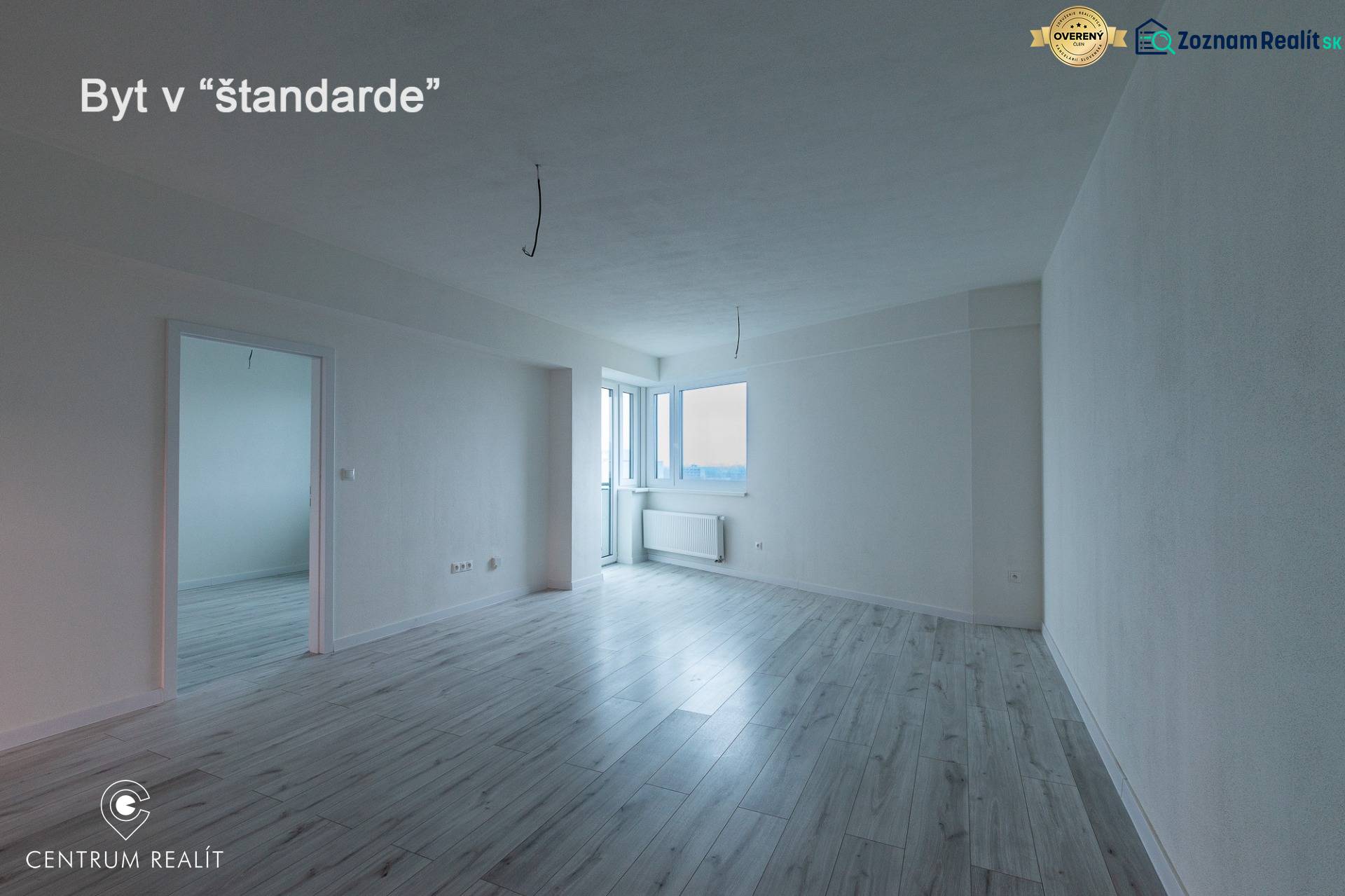 Spacious living room in a 2-room apartment with a wooden decor floor.