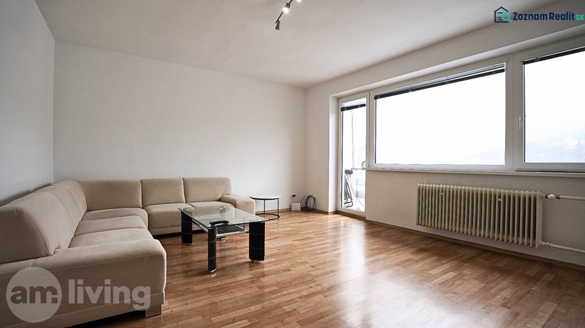 Living room in a 3-room apartment with a corner sofa and a wooden decor floor.