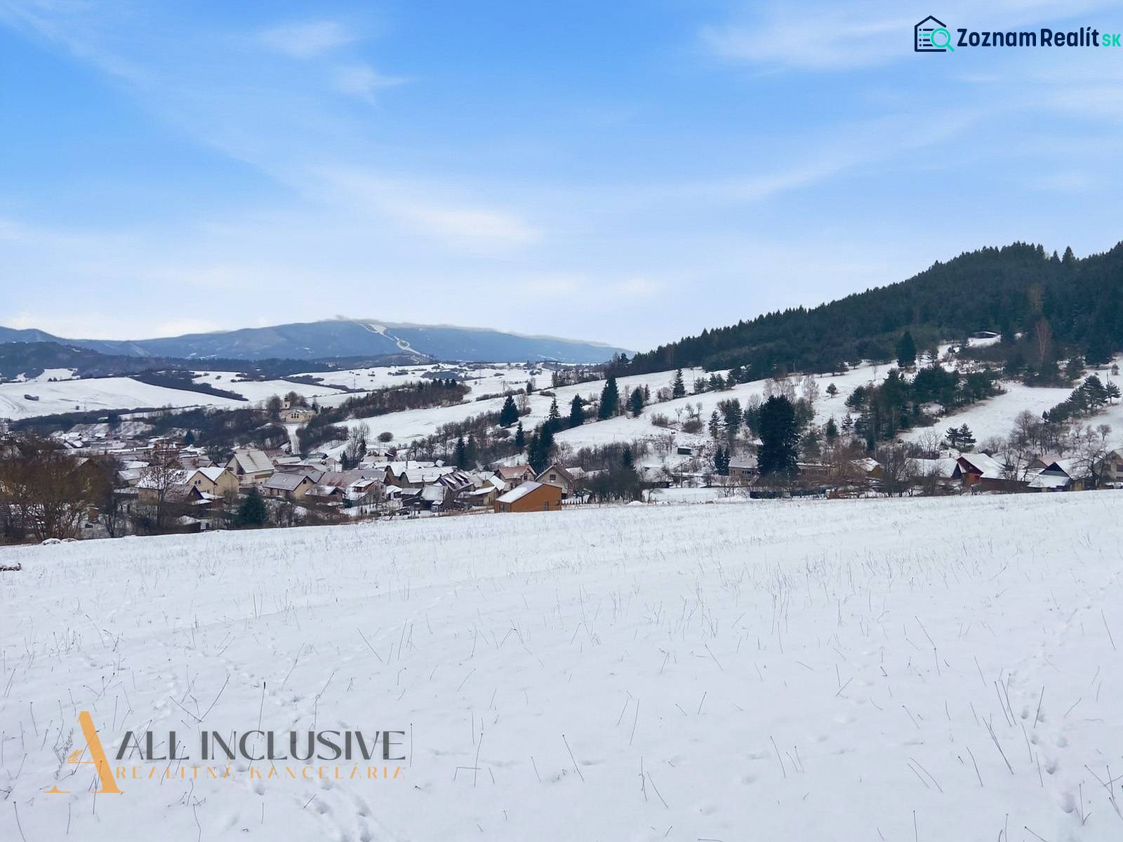 Snowy landscape of Komjatná with a view of dwellings and hills, suitable for plots - housing.