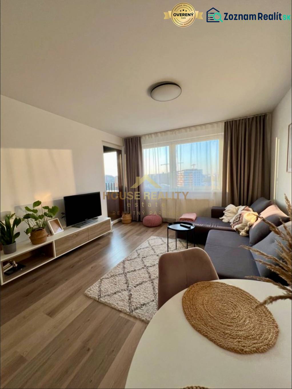 Living room with a sofa, television, and floor with wood decor in a 2-room apartment.