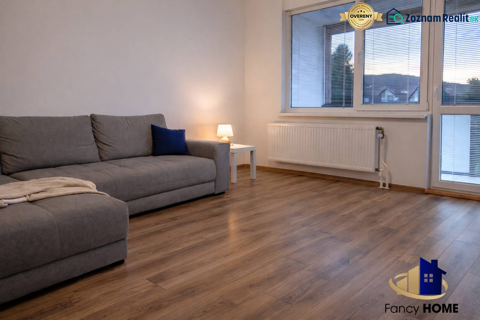 Living room in a 3-room apartment with a sofa and a wooden decor floor.