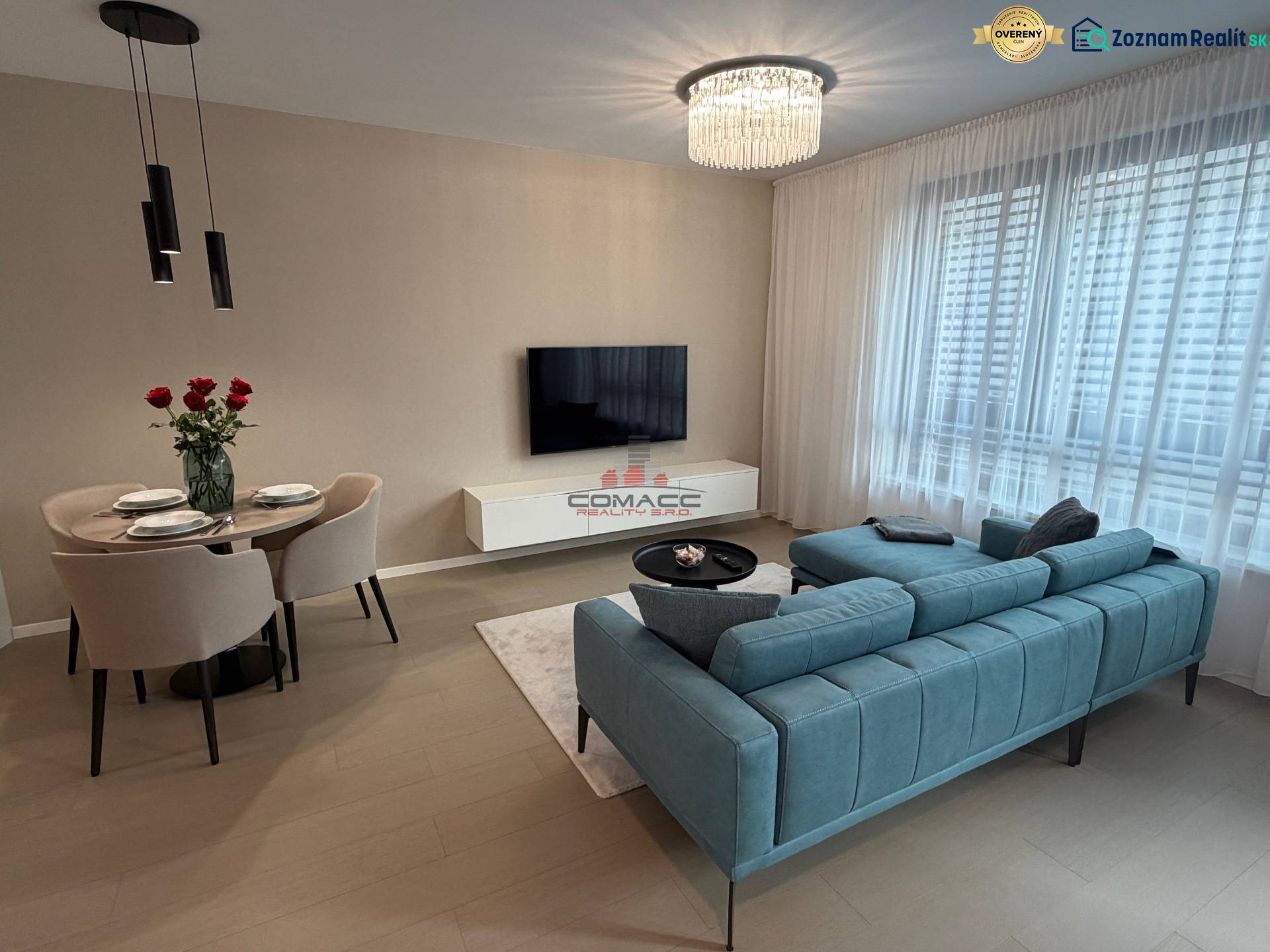 Living room in a two-room apartment with a wooden decor floor and comfortable seating.