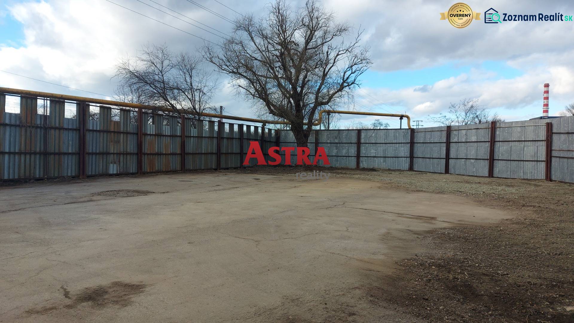 Commercial land in Košice - Juh district with fencing and trees.