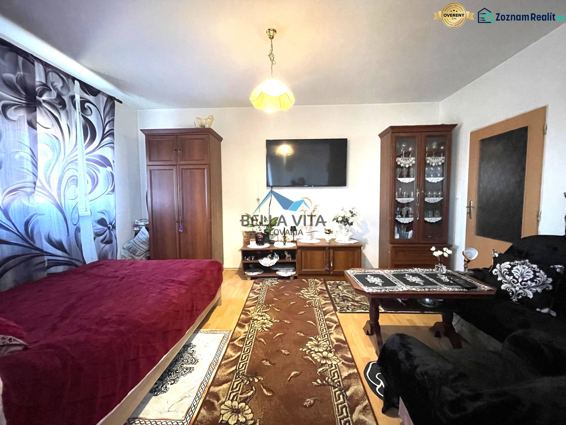 Living room in a one-room apartment with a wooden decor floor and furniture.