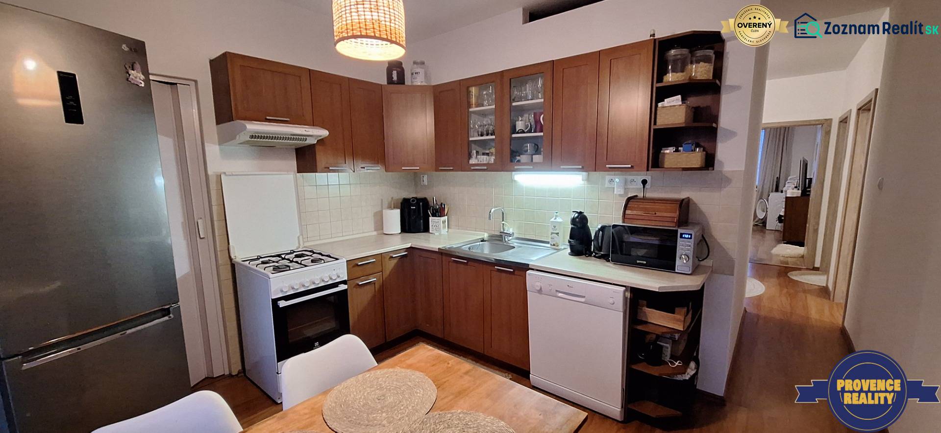 A kitchen in a 4-room apartment with a wooden decor floor, including equipment.