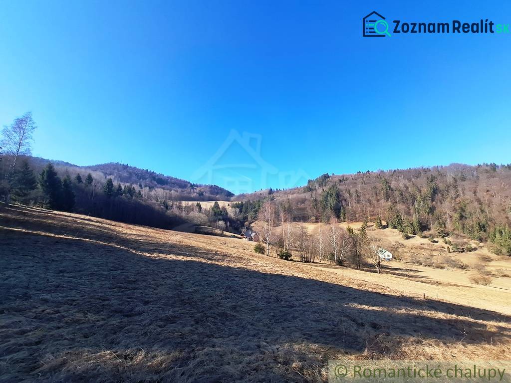 Extensive agricultural and forest lands around Hronec surrounded by forests and hills.