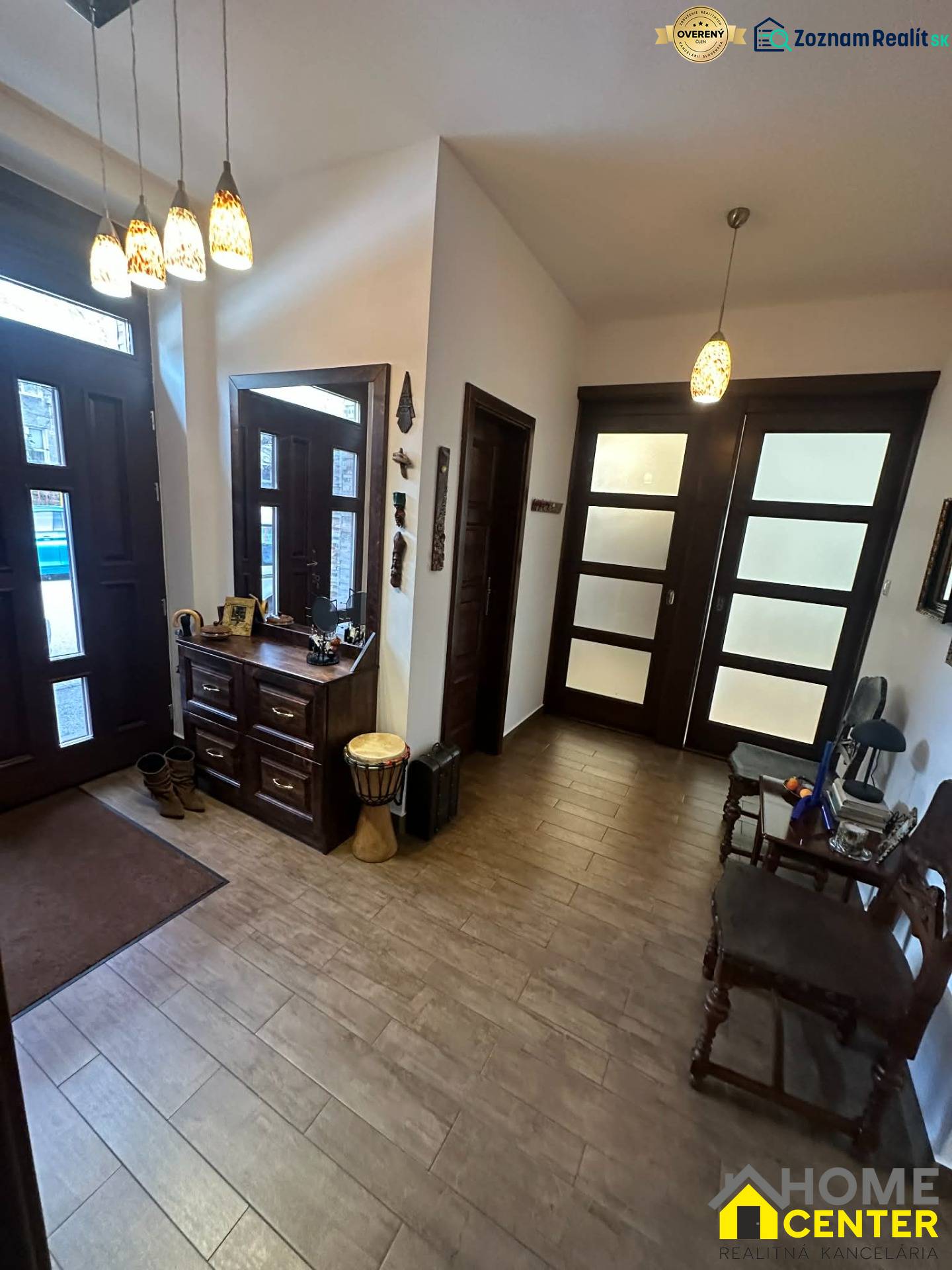 Interior of a family house with a wooden decor floor, storage space, and decorative lighting.
