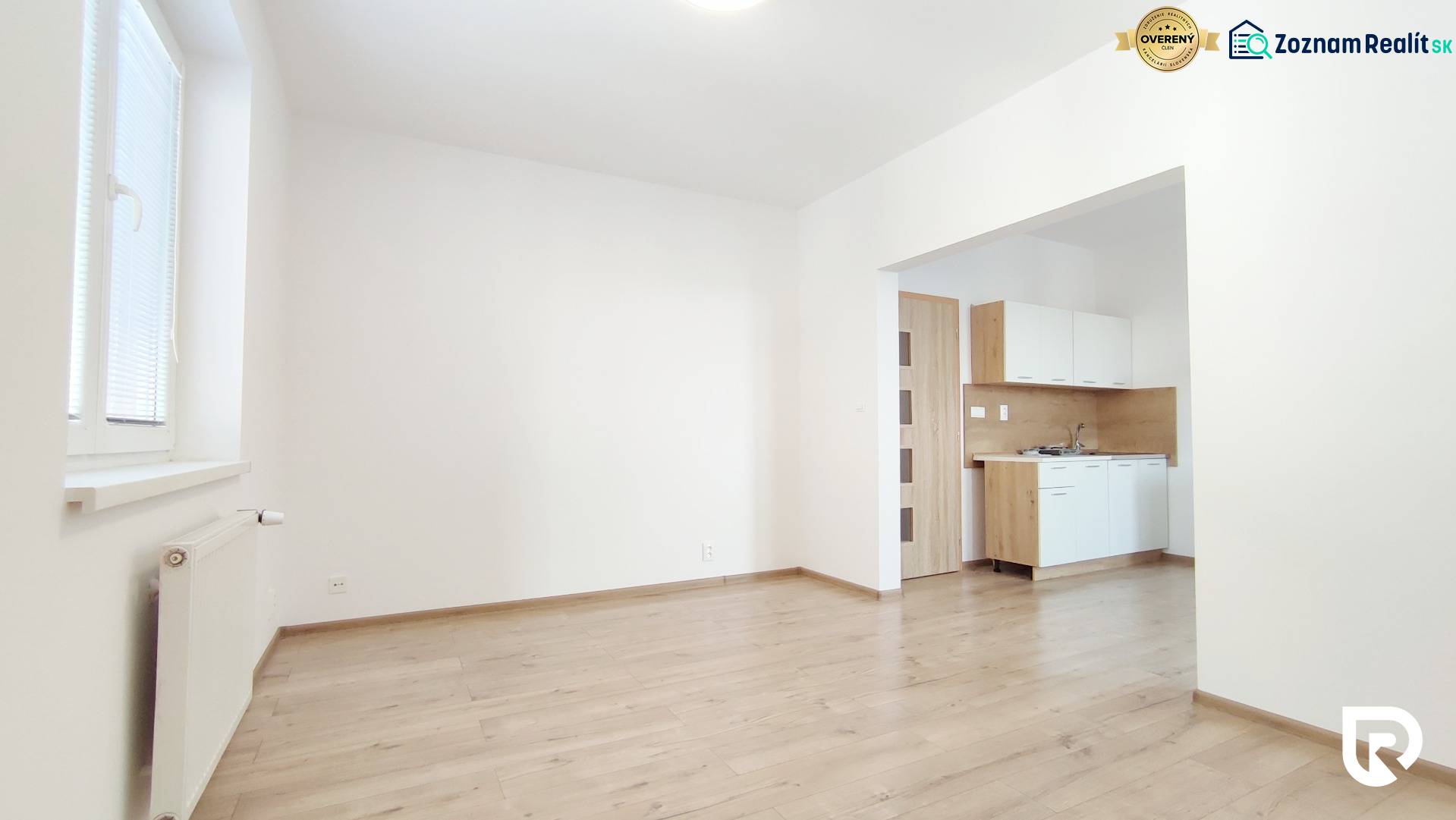 Interior of a 2-room apartment with a kitchen and a wooden decor floor.