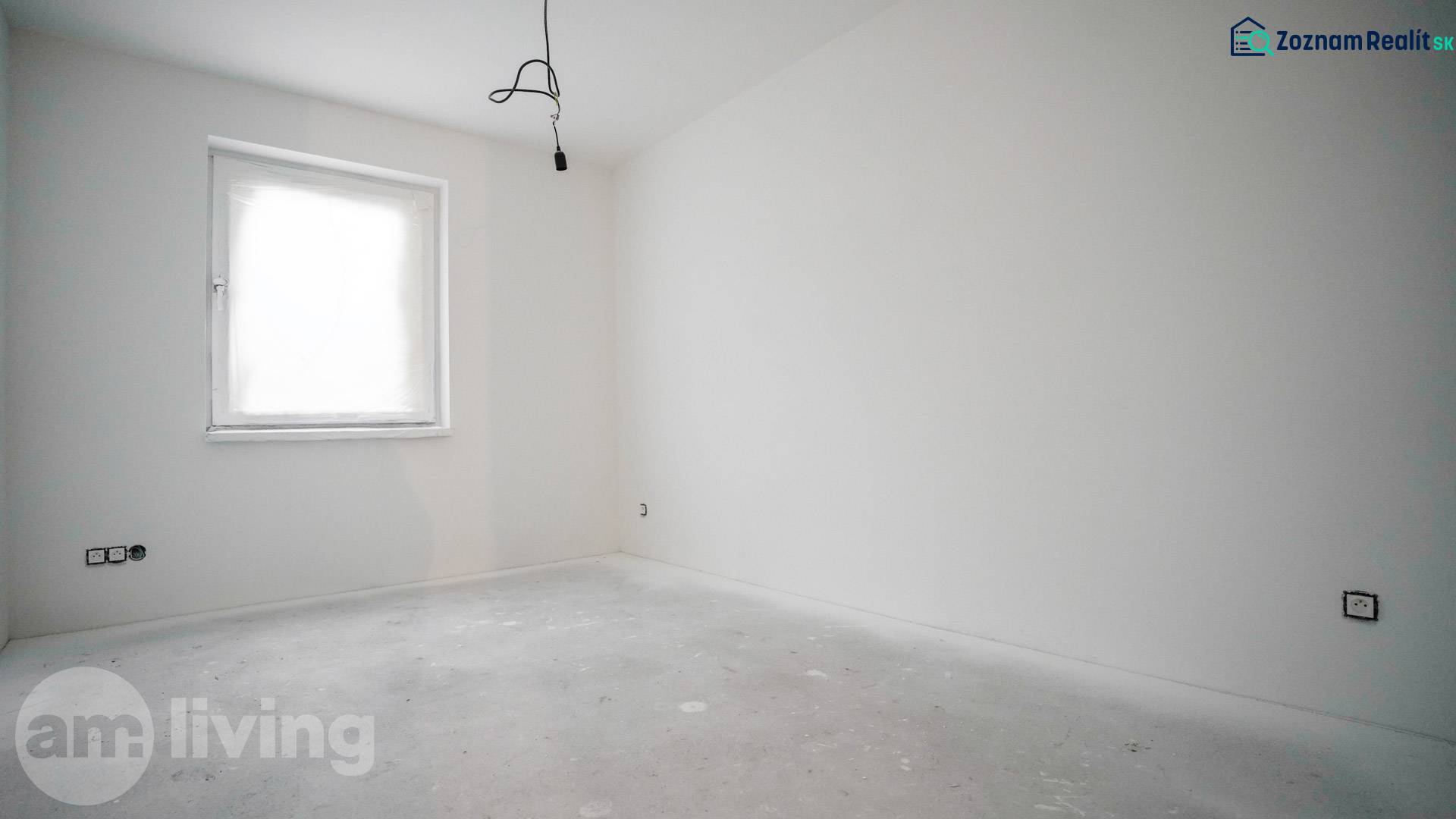 Empty room with white walls and a bright window in a family house.