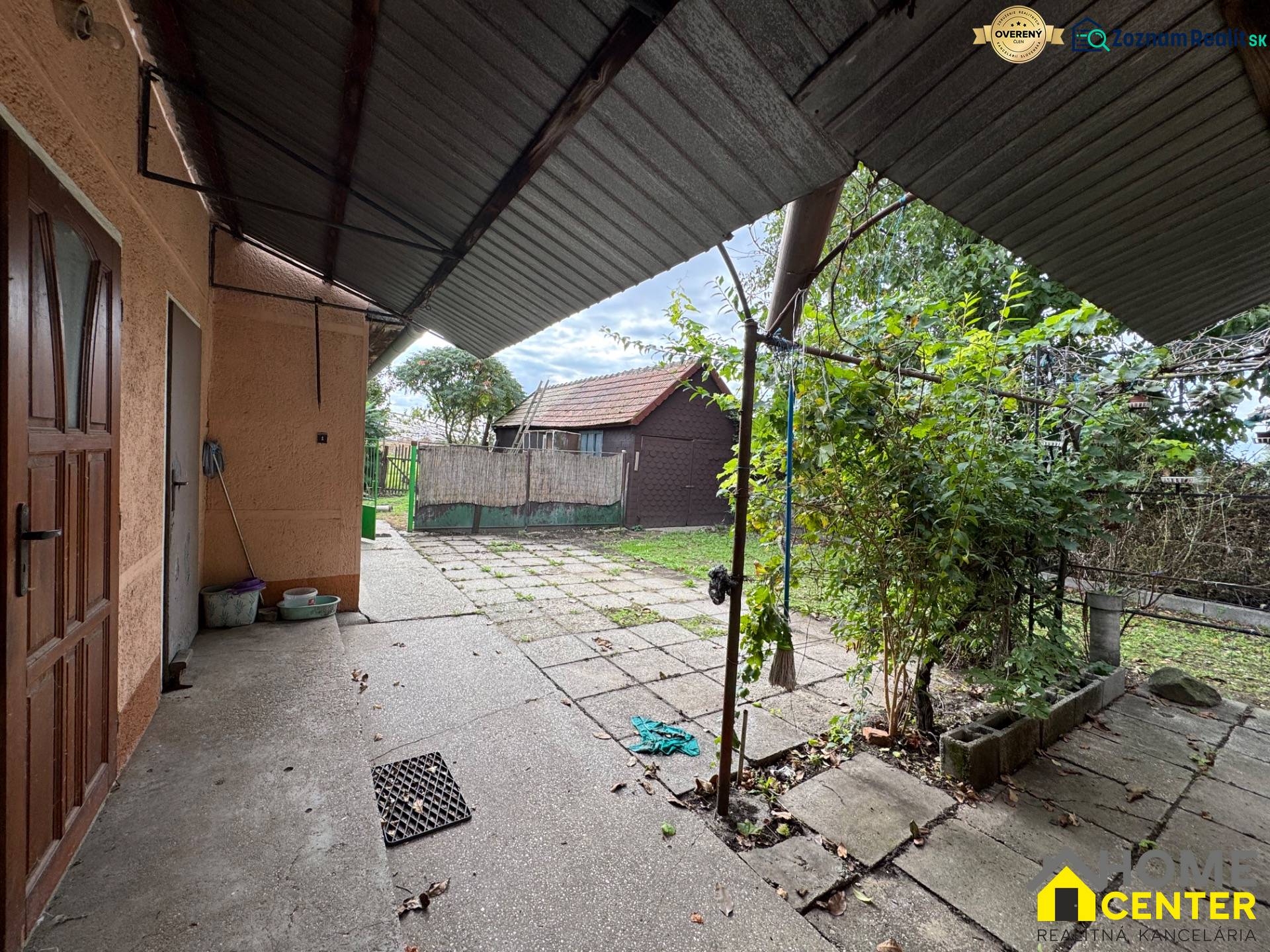 A family house in Komárno with a spacious yard and a gazebo, surrounded by greenery.