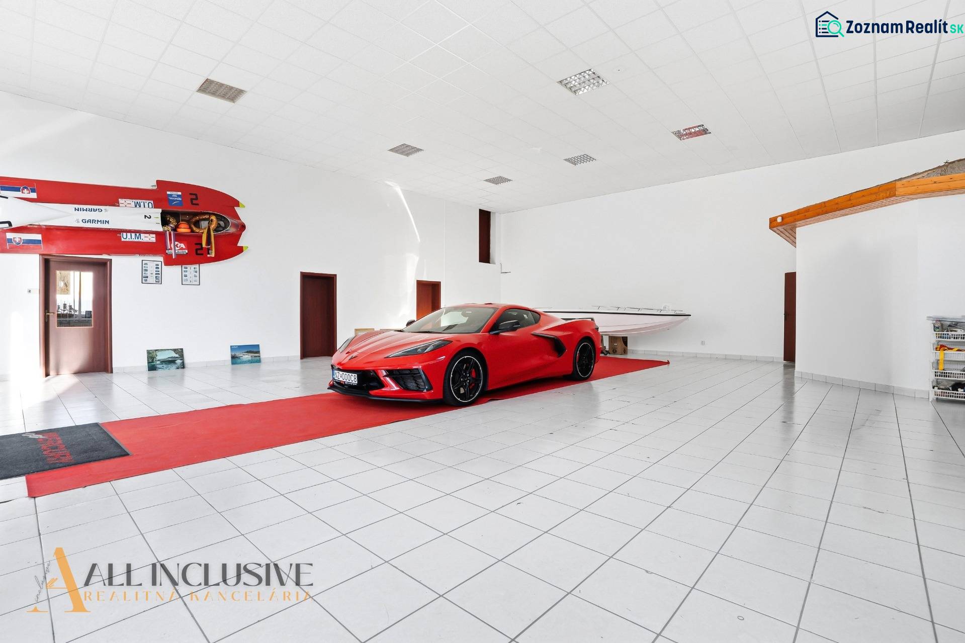 The commercial premises display a car and a boat with a white floor and sports equipment.