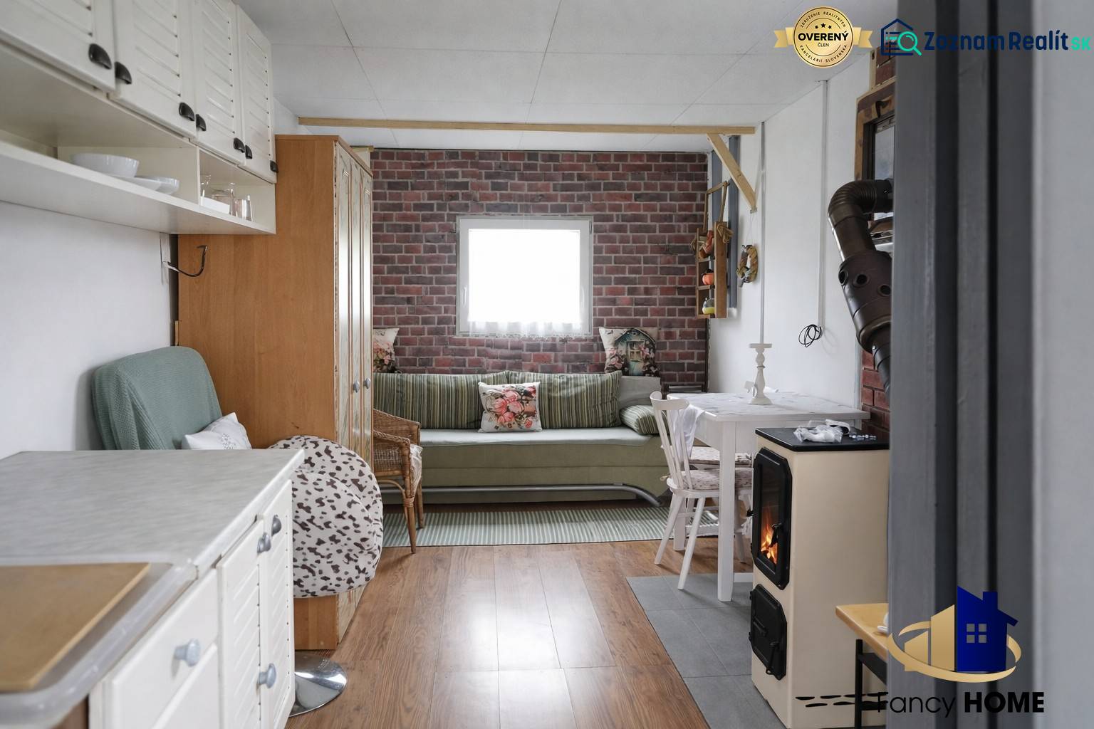 Living room with wood-patterned flooring and brick cladding, Gardens.