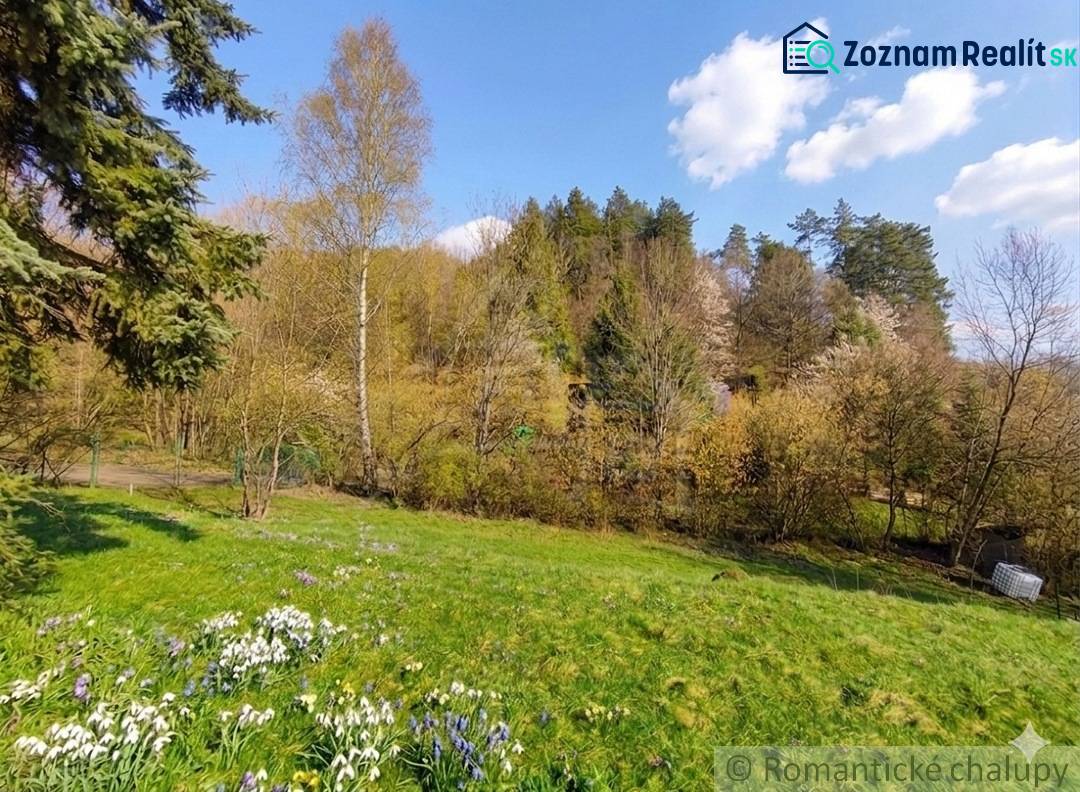 Spring landscape in the gardens in Ľubietová with blooming flowers and trees.