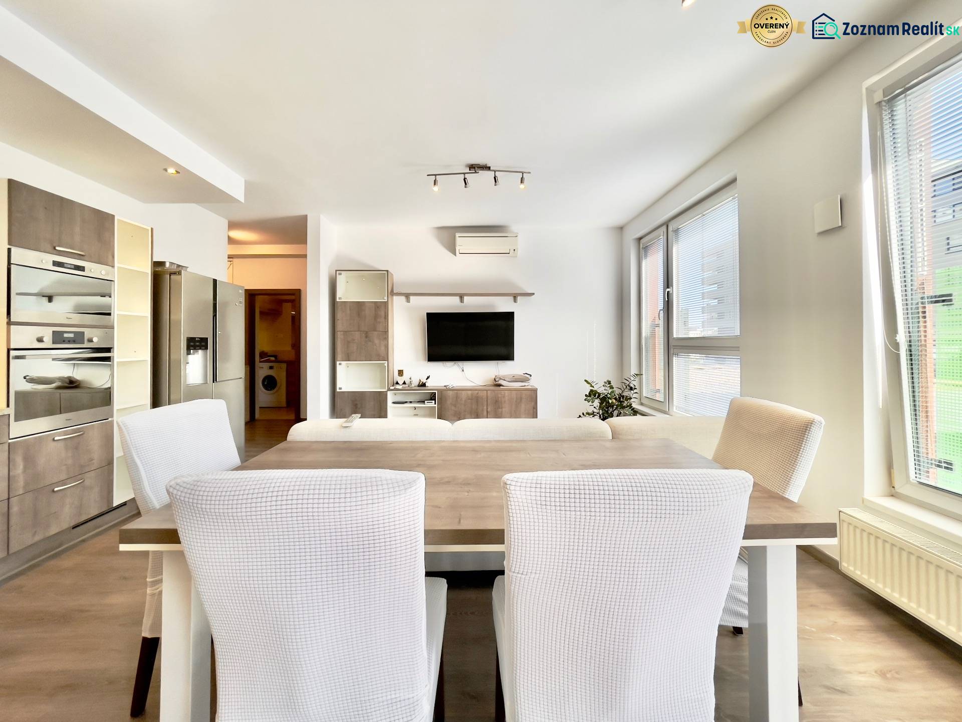 Living room connected with the kitchen, wooden decor flooring, spacious 3-room apartment.