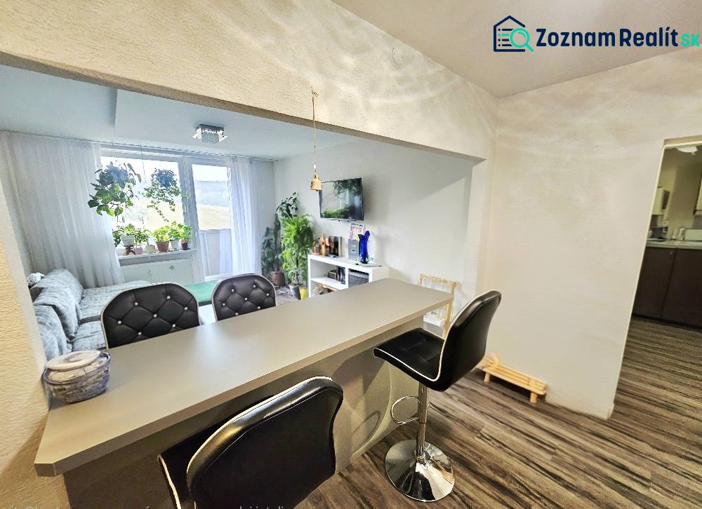 3-room apartment with a bar counter and comfortable seating, floor with wooden decor.