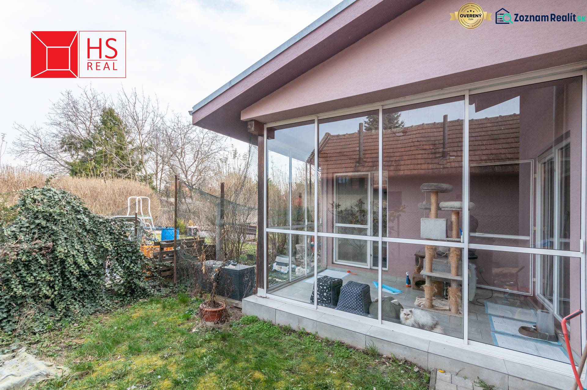 A family house in Šurany with a glass veranda and a garden full of greenery.