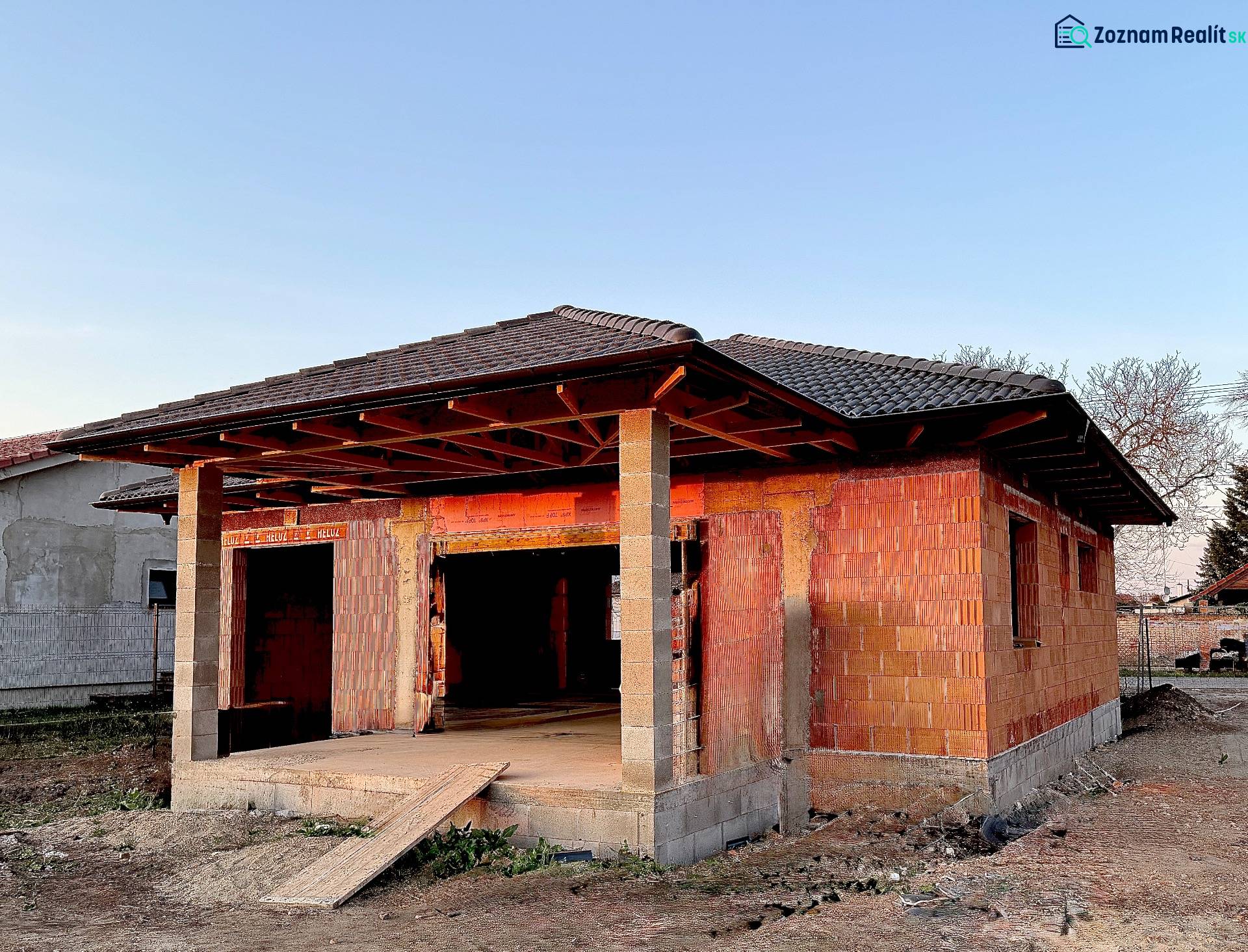 A family house under construction in Andovce with unfinished walls and roof.