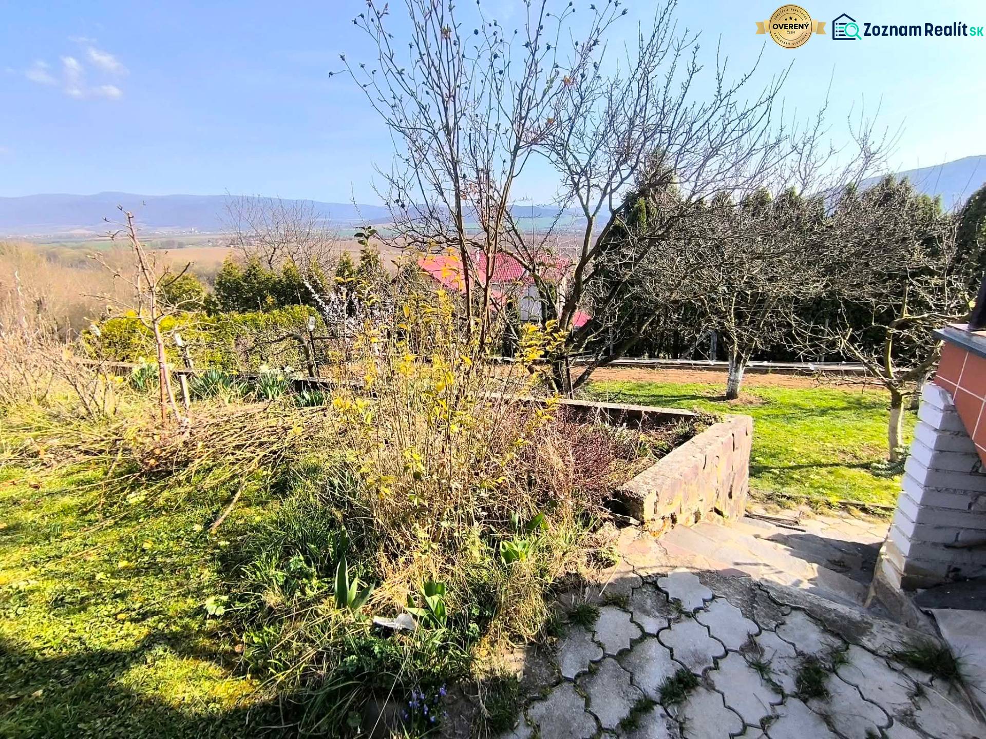 Garden view with fruit trees and mountains in the background in Partizánske near the cottage.