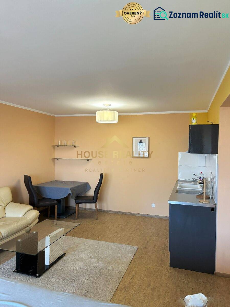 Living room with a kitchenette in a 3-room apartment, floor with wood decor.