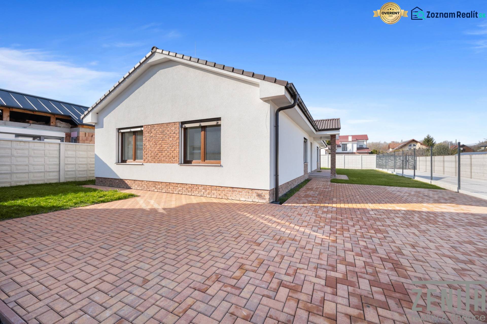 A family house in Vojka nad Dunajom with a brick facade and a paved courtyard.
