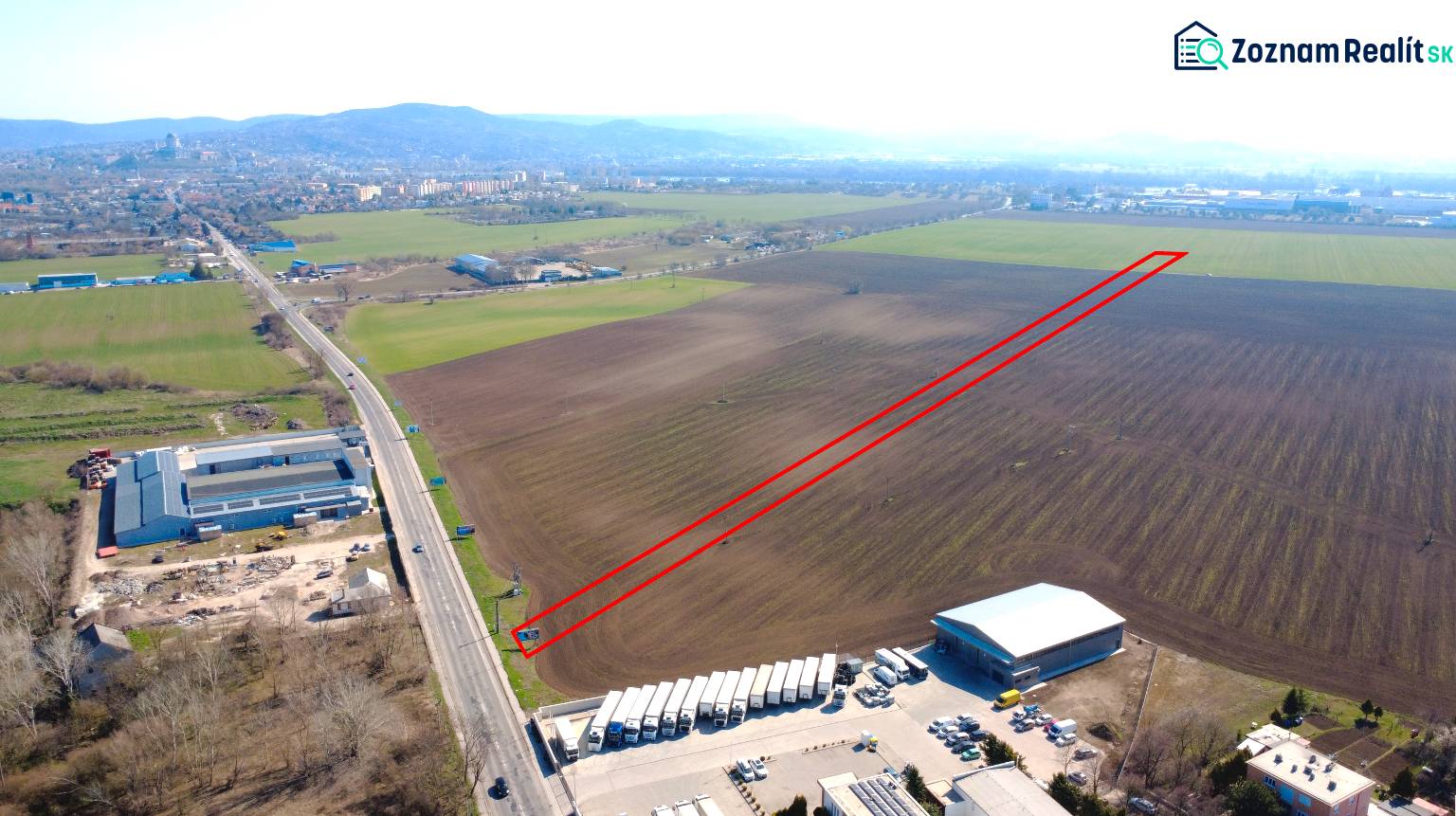 Agricultural and forest lands in Štúrovo with extensive flat areas and an adjacent road.