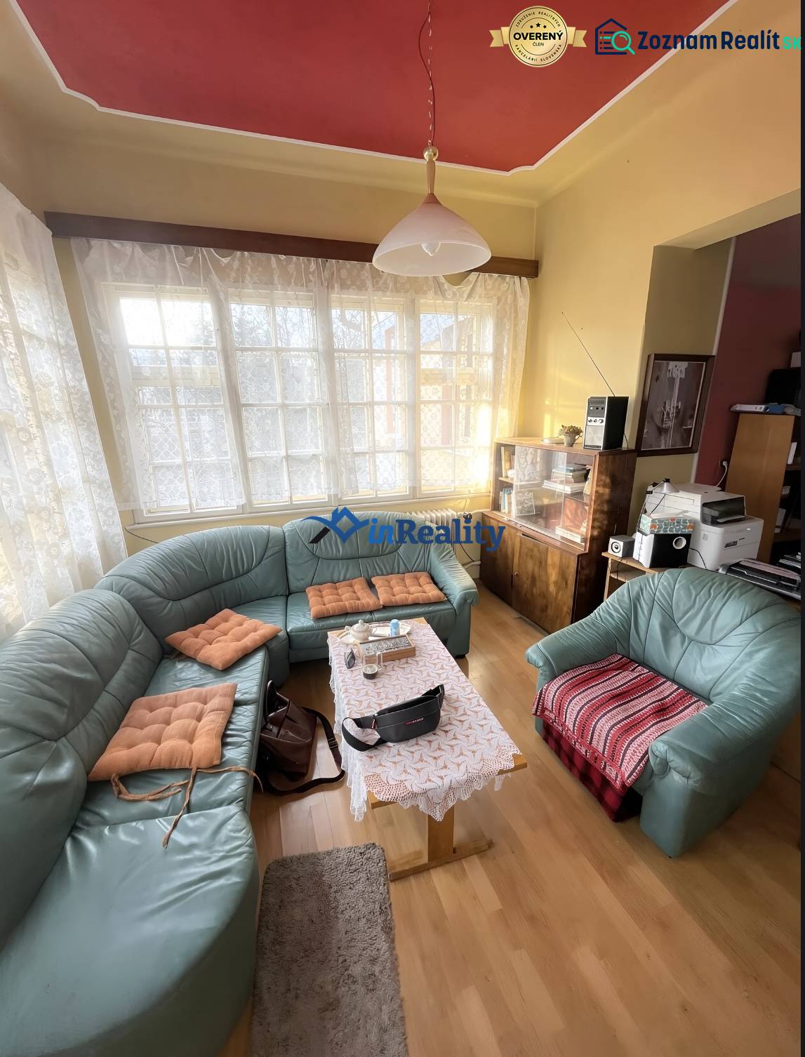 Living room in a family house with a curved sofa and a wooden decor floor.