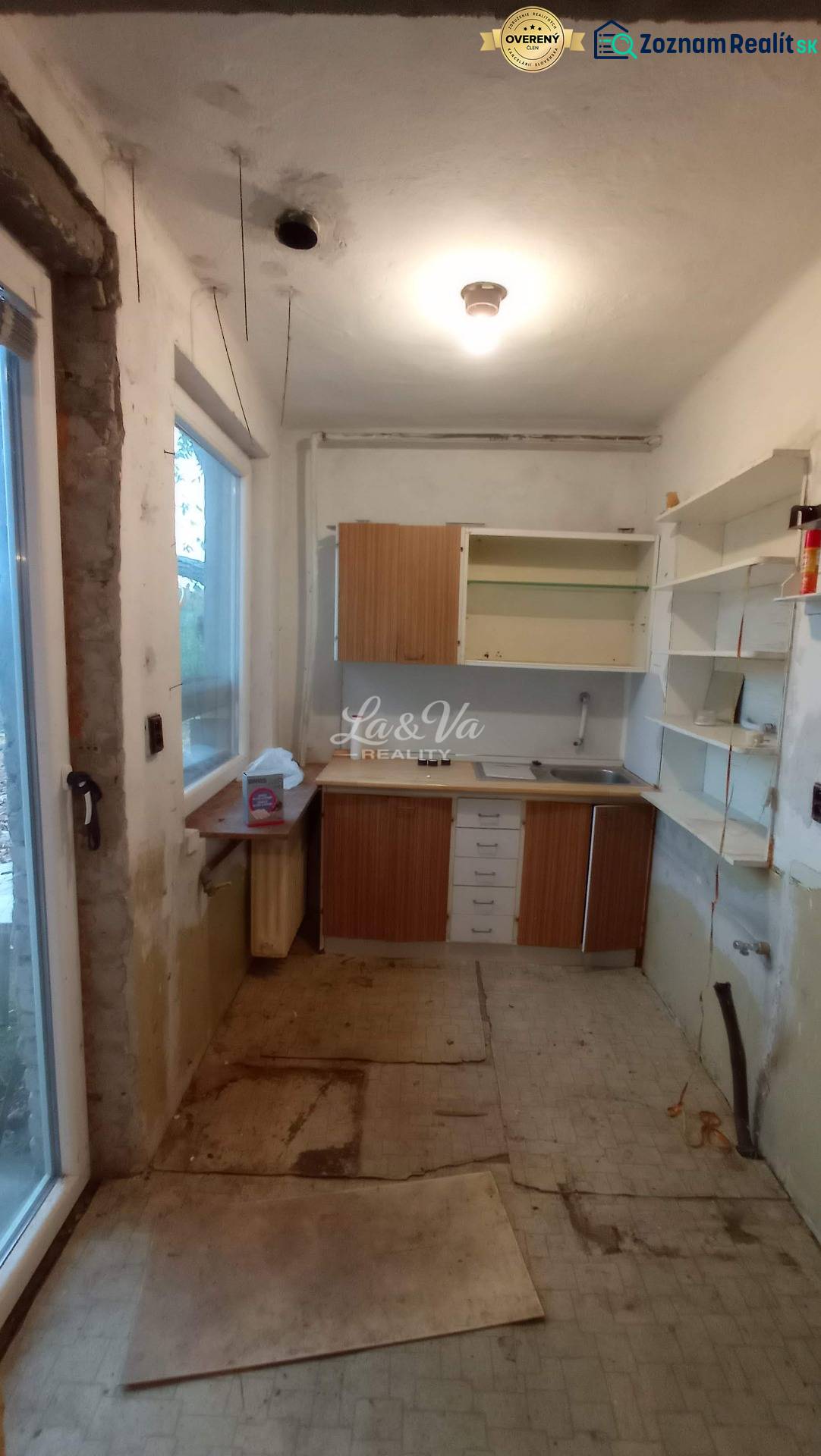 A kitchen in a family house with incomplete renovation and storage space.