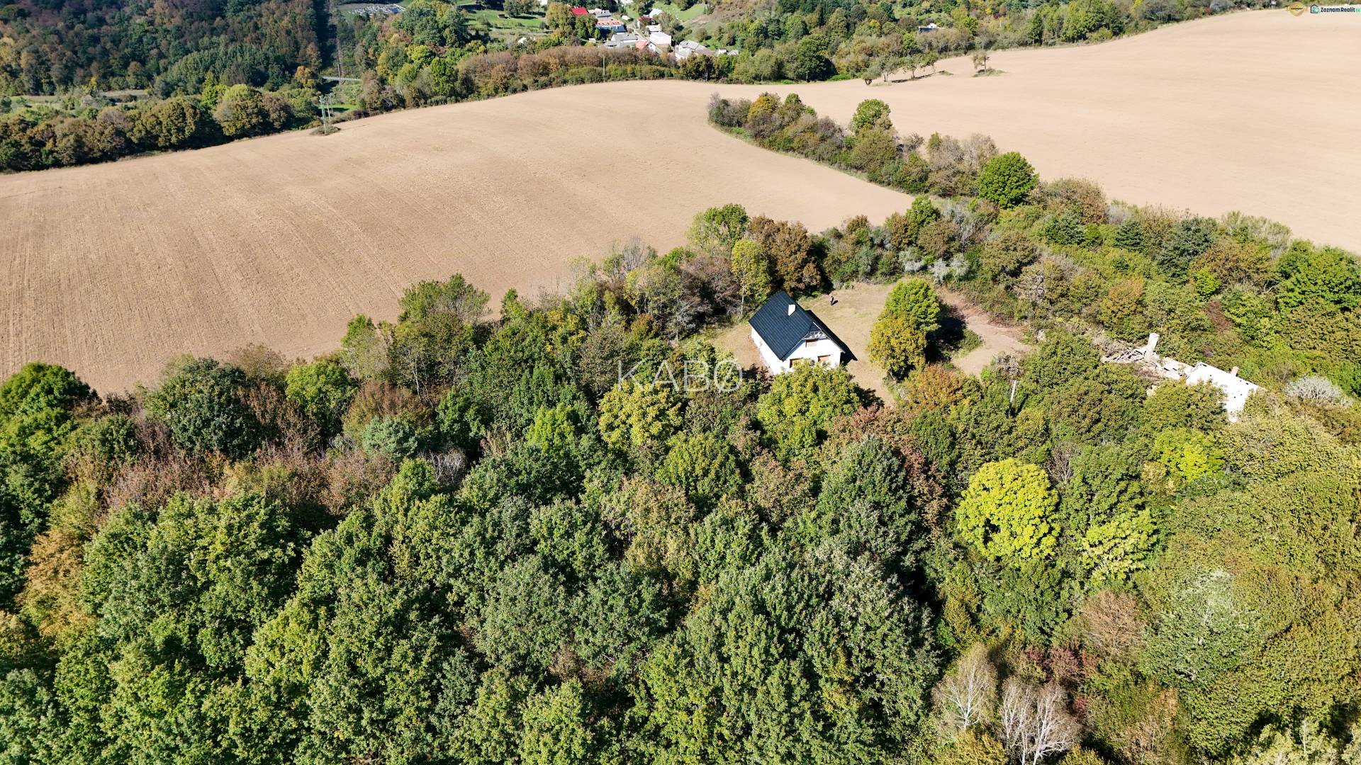 Aerial view of agricultural and forest land near Lackov surrounded by trees and fields.